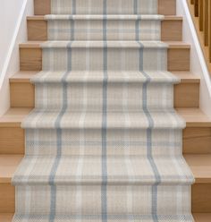 the stairs are lined with plaid carpet