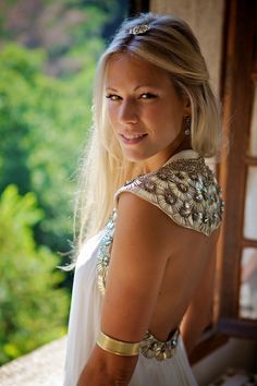 a woman in a white dress posing for the camera