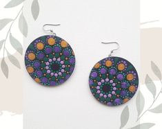 Original hand-painted earrings in this pattern made only once, very light to wear, colorful with a mandala motif, made with the intention of love. Made on a wooden disc (plywood). Diameter is 2 inches (5 cm), weigh 9 grams, painted with acrylic paints, painted dotart, protected by varnish. Stainless steel earwires. The back is black. I can make custom earrings in the colors you dream of with silver or gold-plated earwires (stainless steel). Who created them for you? My name is Karolina Kanimani, I follow the path of conscious development, I am passionate about nature and beauty and I LOVE to create. With joy and passion I create Mandalas from the Heart space, giving each an individual intention. I trained on courses to create Mandalas as a symbol of the Wheel of Life. I invite you to my In Mandala Earrings, Mandela Earrings, Hand Painted Multicolor Dangle Earrings, Multicolor Heart-shaped Hand Painted Earrings, Artistic Hand-painted Purple Earrings, Hand Painted Earrings, Wheel Of Life, Custom Earrings, Pattern Making