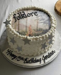 a birthday cake with an image of a person in the woods on it and stars