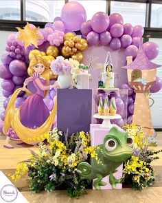 there is a birthday display with balloons and princesses in the background, as well as other decorations