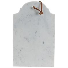 a white marble plaque with a brown cord attached to it