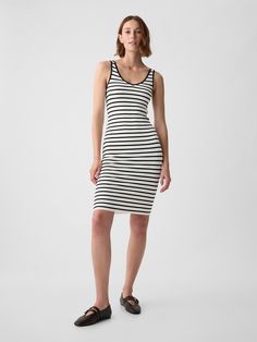 Soft ribbed midi tank dress.  V-neck.  Sleeveless.  Certain styles have allover prints.  * Fit: Slim.  A slim silhouette that fits close to the body.  Hits below the knee.  Models wearing Gap Tank Top Pencil Dress, Casual Fitted Striped Sleeveless Dress, Fitted Striped Sleeveless Dress, Striped Sleeveless Fitted Bodycon Dress, Striped Sleeveless Midi Dress, Lined, Striped V-neck Midi Dress For The Beach, Midi Tank Dress, Black Tank Dress, Everyday Wardrobe