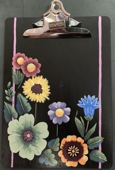 a clipboard with flowers painted on it