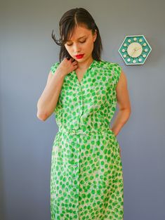 "DESCRIPTION * vintage dress from 1950s by Adele Martin * made with pure silk, in abstract green print * sheath dress style: form-fitting, a straight cut, and the waistline is slightly nipped, accentuating the long slim silhouette. * shirt collar, sleeveless * button down to the hip area * comes with matching belt * beige lining skirt * tag reads \"Adele Martin/ WPL 7588, 100% Pure Silk, Exclusive of Ornamentation, lining and trimming, Dry Clean Only/ Size 12/ Union Label ABFY 160866\" CONDITION Green Fitted Sleeveless Vintage Dress, 1950s Style Sleeveless Green Dress, Green Vintage Style Dress For Summer, Green Vintage Dress For Summer, Green Knee-length Vintage Dress, 1950s Green Short-sleeved Dress, 1950s Style Green Vintage Dress For Spring, 1950s Style Green Short Sleeve Dress, 1950s Green Short Sleeve Dress