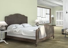 a bedroom with yellow walls and white furniture