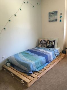 a bed made out of wooden pallets in a room with carpeted flooring