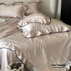 an unmade bed with ruffled sheets and pillows