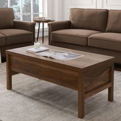 a living room with two couches and a coffee table in front of a window