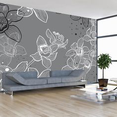 a living room with a couch and flower wallpaper