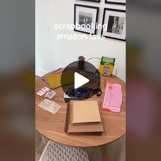 a table with books, notebooks and pictures on it