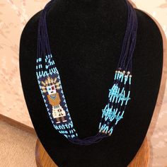 New, Never Worn Native American Seed Beaded Necklace (9 Strands). Handmade Southwestern Blue Beaded Necklace, Artisan Blue Beaded Chain Necklace, Artisan Blue Beaded Chain, Artisan Blue Beaded Necklace, Southwestern Blue Beaded Necklaces For Gift, Traditional Blue Multi-strand Beaded Necklaces, Southwestern Style Blue Beaded Necklace For Gift, Seed Beaded Necklace, Brown Bottles