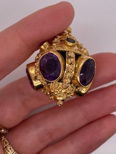 Vintage 18k yellow gold talisman pendant with amethyst and multi color gemstones. There are 5 bezel set amethyst gemstones that measure about 11 x 9mm. There are 2 pink tourmaline, 2 green tourmaline, and 1 citrine set in bezels around the top. The charm weighs 21.48 grams of gold. Talisman Pendant, Plain Bands, Boston Ma, Green Tourmaline, Amethyst Gemstone, Heart Of Gold, Pink Tourmaline, Heart Charm, Citrine