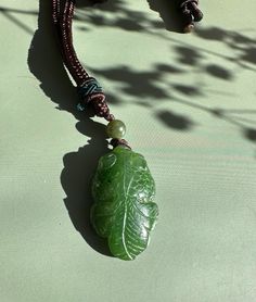 Hand-Carved Canadian Nephrite Jade Pendant The jade measures approximately 1.25" long on an adjustable nylon cord. Green Spiritual Jewelry With Adjustable Cord, Adjustable Green Carved Necklace, Adjustable Carved Nature-inspired Jewelry, Adjustable Green Carved Necklaces, Green Pendant Jewelry With Adjustable Cord, Jade Charm, Jade Bangle, Jade Earrings, Nephrite Jade