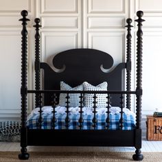 a black bed frame with blue and white pillows