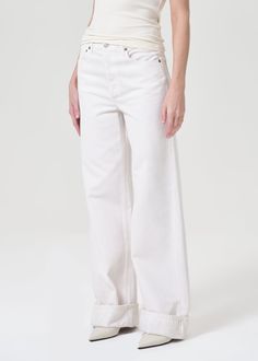 The cuff trend continues with our Dame Jean. Featuring a waist-accentuating high-rise, a relaxed, wide leg, and an untacked cuff. Create an ultra-flattering look by styling the statement fit back to a sleek tee. Intended to have a relaxed fit. For a higher, closer fit, we recommend sizing down. Looks Like: Eggshell warm white Feels Like: Midweight zero-stretch organic cotton with a subtle drape for all day ease Agolde Pinch Waist Kick, Agolde Lyle, Agolde Mia Jeans, Agolde Cherie Jeans, Agolde Pinch Waist High Rise Kick Jeans, Frankies Bikinis, Corset Crop Top, Fortune Cookie, Skirt Jumpsuit