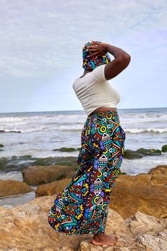 Bola Pants Makossa are designed for ultimate comfort and style. Their elastic waistband provides a secure fit for any body shape, and the wide-leg silhouette creates an elegant and confident look. The high waist emphasizes curves, and the vibrant African print fabric is sure to make a statement. With one size fitting most, you can be sure of finding the perfect fit and has pockets! Multicolored high waist wide leg one size fits most Summer Wide Leg Bottoms With Bold Print, Summer Wide-leg Bottoms With Bold Print, Summer Bold Print Wide Leg Bottoms, Multicolor Pants Loosely Fitted For Vacation, Casual Wide Leg Bottoms With Vibrant Print, Multicolor Bold Print Wide Leg Pants, Casual Wide Leg Pants With Bold Print, Multicolor Wide-leg Pants With Bold Print, Multicolor High-waisted Wide Leg Pants With Elastic Waistband