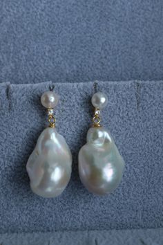 Indulge in the captivating femininity of our double baroque pearl sterling silver dangle earrings, designed to elevate your special occasion with an enduring sophistication. With a delicate 7 mm round pearl accented by petite CZ stones for a hint of sparkle, and a larger dangling white baroque pearl, these earrings epitomize the essence of bridal elegance. Allow theese earrings to accompany you exquisitely, as the baroque pearl sways gracefully with your every step, bestowing a dash of charm to Pearl Drop Baroque Pearl Earrings For Anniversary, Anniversary Baroque Pearl Drop Earrings, Anniversary Drop Earrings With Pearl Charm, High Luster Baroque Pearl Drop Earrings, Formal Drop Earrings With Baroque Pearls, Baroque Pearl Pendant Earrings For Formal Occasions, Anniversary Teardrop Pearl Earrings With High Luster, High Luster Pearl Drop Earrings, Teardrop Baroque Pearl Earrings For Anniversary