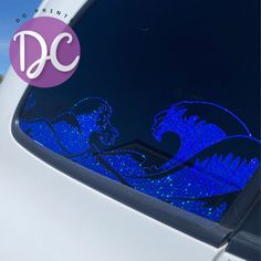 a car that has some kind of blue sticker on the side of it with an image of two mermaids