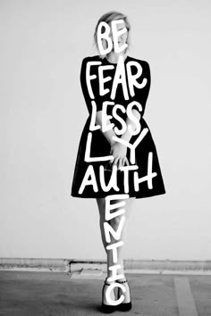 a woman in a dress with words written on her body and the word be fear less, laugh every day