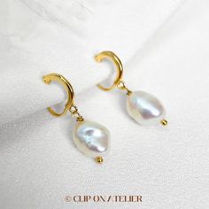 * Style: Minimalist, Classy, Elegant * Material: Gold-plated brass, Freshwater Baroque Pearls (natural pearl, each is unique) * Dimension:  Approximate overall length: 2.2 cm-2.8 cm.  * Please note that the size and shape of the pearls vary from pair to pair. *  * ❀ *  * ♥ ♥ How to wear coil pad clip-on earrings?  All you have to do is slip the clip-on onto your earlobe, press the coil pad and it will stay. ❗️❗️For wearing tips, please go to the "About" section, we've filmed a video for how to w Wedding Gold Plated Hoop Earrings With Pearl Drop, Elegant Brass Hoop Earrings With Pearl Drop, Gold Plated Hoop Earrings With Ear Wire For Wedding, Elegant Brass Dangle Huggie Earrings, Classic Gold Plated Huggie Earrings For Wedding, Gold Hoop Bridal Earrings With Pearl Drop, Delicate Yellow Gold Huggie Earrings For Wedding, Gold Plated Hoop Earrings With Pearl Charm For Wedding, Gold Pearl Huggie Earrings For Wedding