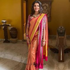 a woman in an orange and pink sari