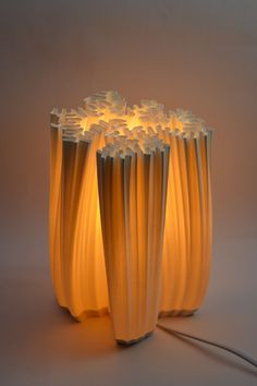 an unusual lamp made out of plastic tubes and lightshades is shown in this image