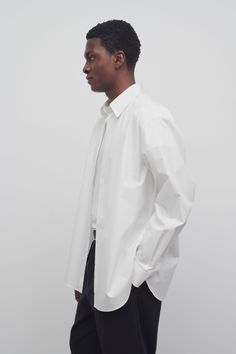 Tailored button-down shirt in woven cotton poplin with exposed placket, horn button closure, and curved hem. Towel Scarf, Mens Fall, Mens Spring, Leather Pouch, Woven Cotton, Womens Fall, Men's Collection, Shirt White, Cotton Poplin