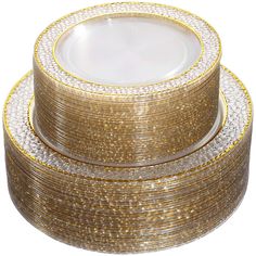 gold and white plates stacked on top of each other