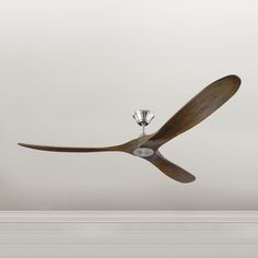 a ceiling fan that is hanging from the ceiling in an empty room with white walls