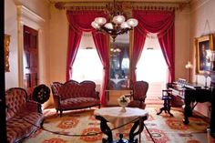 a living room filled with furniture and a chandelier