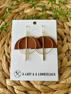 These earrings measure approximately 1 3/4" wide x 2 1/4" drop (including hook). Made with hypoallergenic 14k gold plated hooks and silicone earring backs, they're perfect for sensitive ears. These are hand crafted from from genuine leather and raw brass which makes such a beautiful combination. Each set is packaged in a brown jewelry box for easy gifting! Our current processing time is 3-5 business days. We ship USPS Ground Advantage with a Priority upgrade available at checkout; both shipping options include tracking which will be sent to you when your order ships.  Need a bulk order or have a custom request? We'd love to hear from you! Please reach out to us at aladyandalumberjack@gmail.com Love your order? We'd love to see it! Please tag us on Instagram @aladyandalumberjack. Nickel-free Gold Earrings For Everyday, Minimalist Brown Brass Jewelry, Gold Earrings For Everyday Use, Modern Brown Earrings With Ear Wire, Everyday Brown Metal Earrings, Adjustable Drop Earrings For Everyday Use, Modern Brown Brass Jewelry, Brown Jewelry, Chestnut Brown