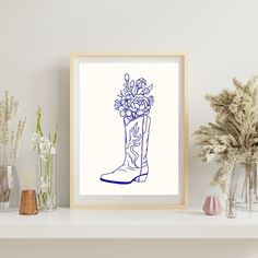 a drawing of a boot with flowers in it on a shelf next to vases