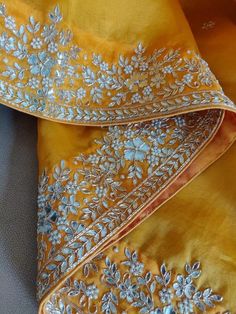 Update! - Zynah covered by LBB - https://lbb.in/bangalore/zynah-designs-handloom-sarees/ This is a precious organza saree in charming yellow color with gotapatti, zardosi, pearl work, and cutwork embroidery, especially for Organza Lovers. The saree features a beautiful floral butis in gotapatti zardosi embroidery work all over the saree. The border is decorated with florals and leaves in gotapatti, zardosi embroidery, adorned with cut-work, and is highlighted with embroidery and pearl work. Colo Saree 2023, Embroidered Suits, Kurtis Design, Stylish Kurtis, Embroidery Sarees, Zardosi Embroidery, Stylish Kurtis Design, Zardozi Work, Pearl Work