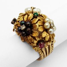 Floral Cocktail Ring Multi Stone 18K Gold Diamonds Vintage 18 K (.750) yellow gold cocktail ring in floral designs, decorated with Seed Pearls, Emerald, Ruby, Sapphire and Diamonds. This fabulous ring is a size 7, 11/16" wide and weighs 14.6 grams. [EA1065] Shipping/Handling/Insurance Policy All items are carefully packed and insured, with no handling or packing fees, ever. Please do not attempt to return an item due to shipping damage. Should it occur in spite of our careful packaging, this must be handled through the shipping agent with an insurance claim. We will be happy to assist in this. Always be sure to retain all original packaging if a claim is to be made as the shipping agent may request to examine it. That being said, in over 10 years of internet shipping, we have had only one Agent May, Amethyst Cocktail Ring, Yellow Gold Cocktail Ring, Floral Cocktails, Antique Jewelry Rings, Gold Cocktail Ring, Star Pendant Necklace, Gold Cocktail, Ruby Sapphire