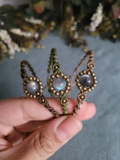 a hand holding a small tiara made out of beads