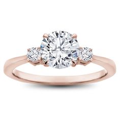 a rose gold engagement ring with three stones