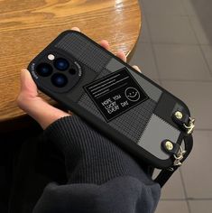 a person holding an iphone case with a camera attached to the back of their phone