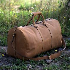 "DIMENSIONS: 12\"H x 23.5\"L x 11\"D Sand Brown Leather Duffel Bag will last you lifetime. Versatile and stylish, this hand made overnight duffle is a timeless classic travel essential. With huge interior, perfect as a weekender or week long trip. This Cabin Luggage is designed using top grain cowhide leather with Crazy Horse finish. Brass Hardware and cotton lining allows this weekender to stay firm and hold on tight for a sweet weekend ride. Inside the handcrafted large duffel, at one end, we Brown Luggage, Leather Overnight Bag, Leather Duffel Bag, Leather Weekender Bag, Leather Duffel, Leather Weekender, Sac Week End, Leather Duffle Bag, Leather Travel Bag