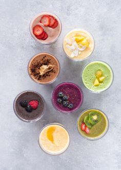 six different types of smoothie bowls with fruit on the top and one in the middle