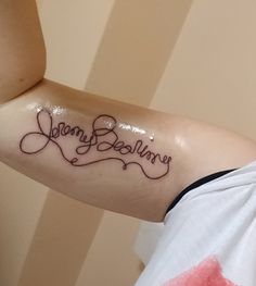 a person with a tattoo on their arm that says, jenny bellowsy in cursive writing