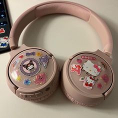 pink hello kitty headphones sitting on top of a table