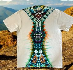 Ice Dye Totem T Shirt, Unisex XL Comfort Colors Tee, One of a Kind Ready To Ship This is a top quality Comfort Colors shirt that I have ice dyed in a totem design.  The colors are blues, greens and orange.   Look for the critters that show up in the totem!  I use quality procion dyes.  Each shirt I list is unique - you will receive this exact shirt.  It has been washed, dried and is preshrunk.  Wash with like (dark) colors.  Tumble dry.   Features of this shirt:  6.1 oz., pre-shrunk 100% ringspu White Relaxed Fit T-shirt For Festival, White Short Sleeve T-shirt For Festivals, White Relaxed Fit Tops For Festival, White Short Sleeve Shirt For Festival, Unisex Short Sleeve Tops For Festivals, Green Short Sleeve T-shirt For Festivals, Festival Tie Dye Short Sleeve Tops, Festival Tie-dye Short Sleeve Tops, Dry Message