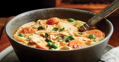 a bowl filled with chicken and vegetables on top of a table