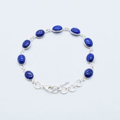 Natural Lapis Lazuli Bracelet, 925 Sterling Silver Lapis Lazuli Bracelet, Handmade Silver Gemstone Bracelet, Solid Silver Bracelet. Metal:- 925 Sterling Silver Gemstone:- Lapis Lazuli Stone Shape:- Oval Stone Size:- 7x9mm Bracelet Length:- 8 inch including 4 extenders. The Bracelet is stamped 925. About Gemstone:- Variously described as indigo, royal, midnight, or marine blue, lapis lazuli's signature hue is slightly greenish blue to violetish blue, medium to dark in tone, and highly saturated. Oval Sapphire Bracelets As Gift, Oval Lapis Lazuli Silver Jewelry, Oval Silver Lapis Lazuli Jewelry, Adjustable Blue Oval Sterling Silver Bracelet, Blue Oval Bracelet As A Gift, Adjustable Oval Sterling Silver Bracelet In Blue, Silver Jewelry With Oval Lapis Lazuli, Adjustable Oval Blue Sterling Silver Bracelet, Blue Oval Bracelet As Gift