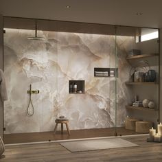 a bathroom with a glass shower door and wooden shelves on the wall next to it