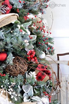 a christmas tree decorated with red, white and green ornaments is displayed in a chair