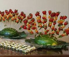 there are many strawberries on sticks in the shape of flowers and watermelon