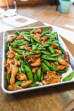 a pan filled with chicken and green beans