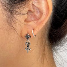 Introducing our Victorian Style Fleur De Lis Dangle earrings, crafted with intricate detail in titanium. These statement pieces are inspired by the iconic style of Chrome Heart, perfect for expressing your unique and bold personality. Add a touch of rebellious charm to your outfit with these striking earrings that are sure to turn heads wherever you go. Elevate your accessory game with these must-have pieces that exude a sense of edgy sophistication. ▪️▪️▪️PRODUCT Sold by pair=2pcs AAA Cubic Zirconia Titanium Hypoallergenic, Lead & Nickel Free VISIT STORE FOR MORE PRODUCT 🔗 https://www.etsy.com/ca/shop/TWISTEEL ▪️▪️▪️ S H I P P I N G   All orders will be shipped on the next business day UNITED STATES  - USPS First-Class Mail * 4 - 14 Business Days  Tracking & Insurance included CANADA - C Formal Drop Cartilage Earrings, Gothic Single Earring As Gift, Gothic Drop Earrings Pierced, Gothic Single Drop Earring, Gothic Drop Earrings, Vampire Aesthetics, Chrome Hearts Earring, Vampire Earrings, Victorian Style Earrings